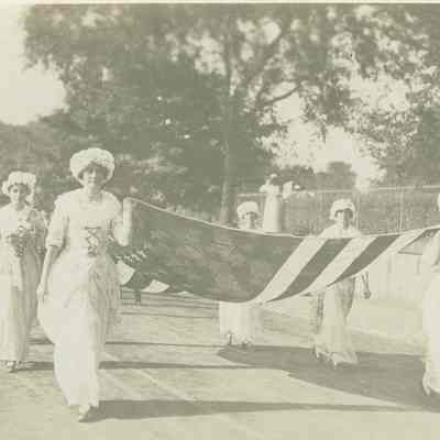 Young women carrying American Flag