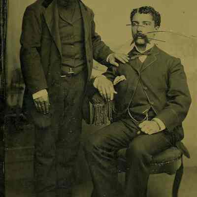Unknown bearded men, one sitting and one standing