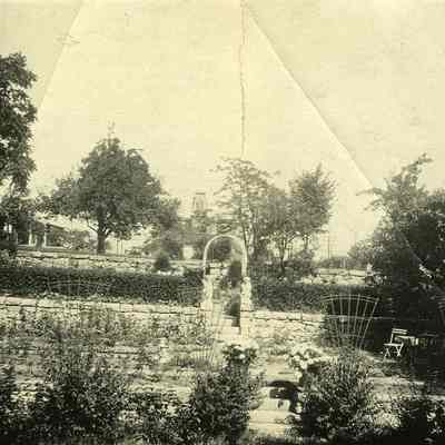Stone wall, steps and angels in garden at "The Hill"