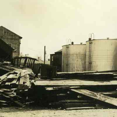 Damaged houses with storage tanks