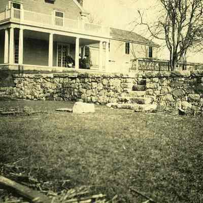 Covered porch at "The Hill" with stone wall