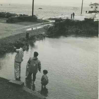 People walking in water near Water Street