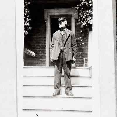 Lighthouse Keeper on front steps of home