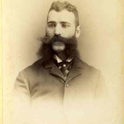 Unknown dark-haired man with "side" whiskers