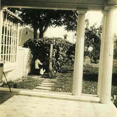 Looking at covered walkway with person from porch at "The Hill"