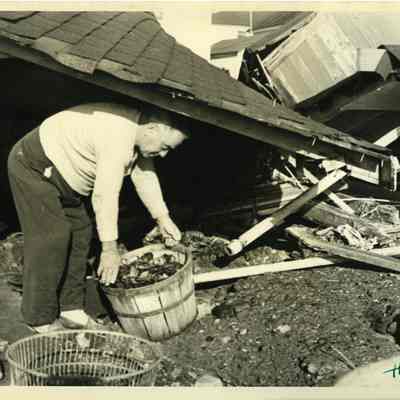 Close-up of man working on debris of demolished house