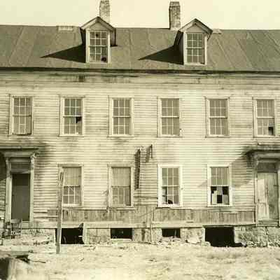 Damaged two story house with two front doors