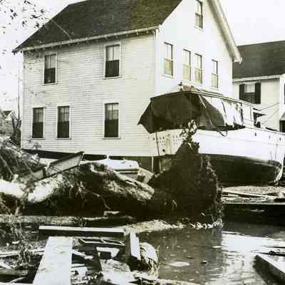 Boat washed up against houses