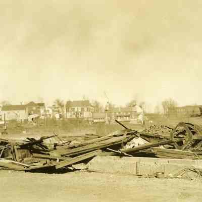 Debris and rubble with houses in background