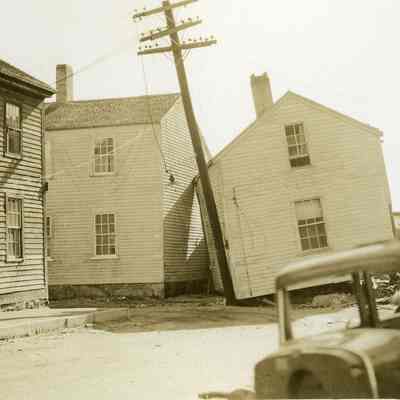 Damaged houses with automobile and fishing boat