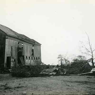 Badly damaged barnlike builing