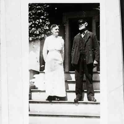 Lighthouse Keeper and wife on front steps