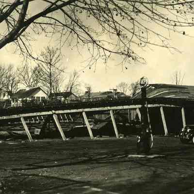 Damaged building structure behind chain-link fence