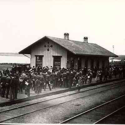 Stonington train depot with people in uniforms(?) looking west towards New London, Stonington CT