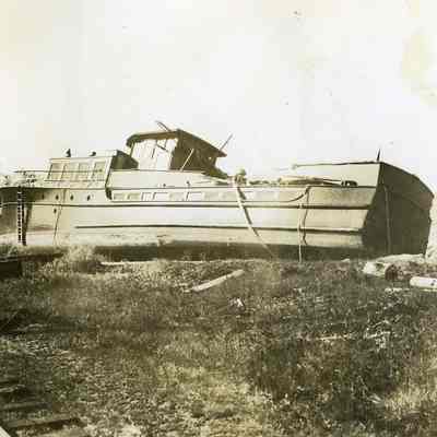 Large boat washed up near railroad tracks