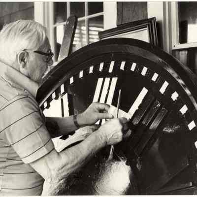 Touching up Congregational clock face