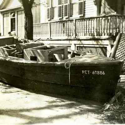 Small boat in front of home