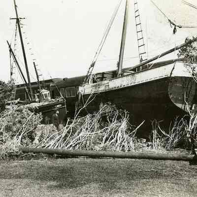 Fishing boats washed against derailed train