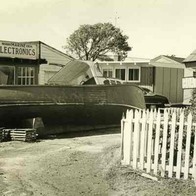 Power boat washed up in front of Noank Marine Exch. Electronics