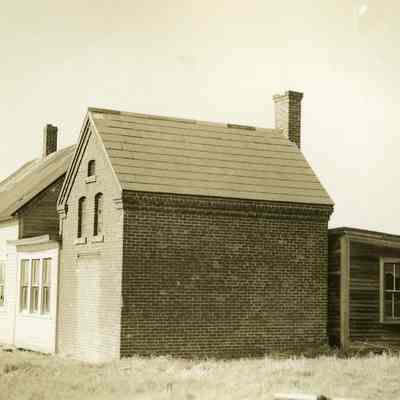 Wooden buildings with brick building attached