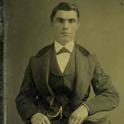 Unknown young man seated, pocket watch on chain