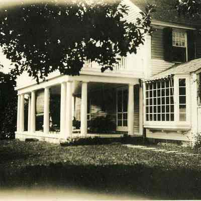 Looking at small porch with one blind down at "The Hill"