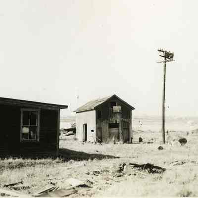 Damaged buildings with utility pole
