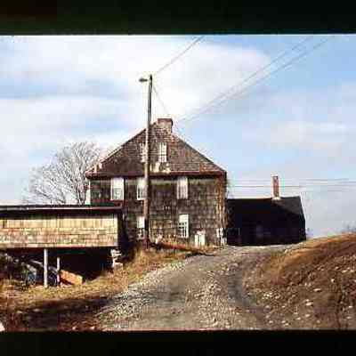Shingled house on dirt road