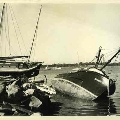 Wrecked boats in harbor on rocks