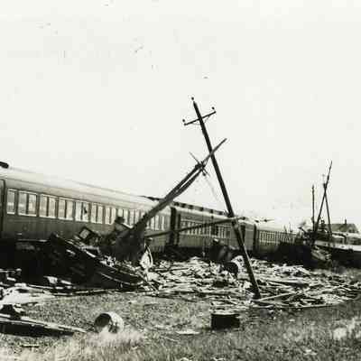 Fishing boats washed against derailed train