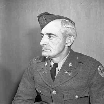 Published In Ann Arbor News, April 29, 1942 Caption New second lieutenant of the Ann Arbor company of the Michigan State Troops is Charles A. Briggs (above), of 1691 Calvin St., who has been promoted from platoon sergeant to succeed James Norris, who has entered the Army. Note he is wearing this style of DUI on his shirt collar.