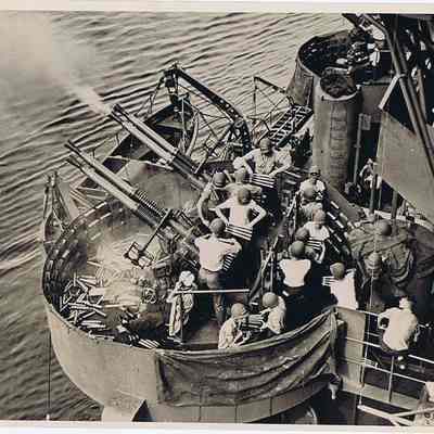 Quad 40mm Gun Tub with crew aboard U.S. Navy vessel in action.
