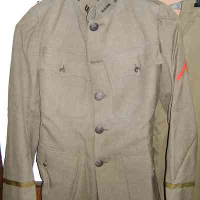 Tunic 4 pocket: M1910 model with engineer pins, lieutenant rank, and red discharge chevron.