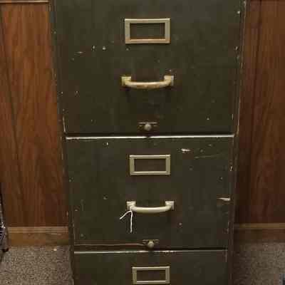 Three drawer file cabinet with Defense Plant Corporation tag