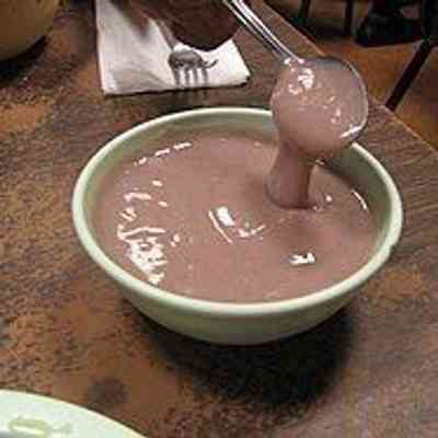 For reference only: A bowl of poi. 
Water is added to the paste during mashing, and again just before eating, to achieve the desired consistency, which can range from highly viscous to liquid. In Hawaii, this is informally classified as either "one-finger", "two-finger", or "three-finger", alluding to how many fingers are required to scoop it up (the thicker the poi, the fewer fingers required to scoop a sufficient mouthful).[4]

Poi can be eaten immediately, when fresh and sweet, or left to ferment and become sour, developing a smell reminiscent of plain yogurt.

Wikipedia Reference nos.