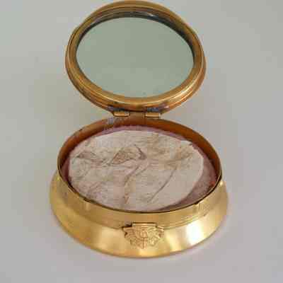 2023.22.1.1: Interior of compact showing powder applicator and mirror.