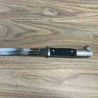 2023.55.1v: K98 Dress Bayonet showing damage to hilt