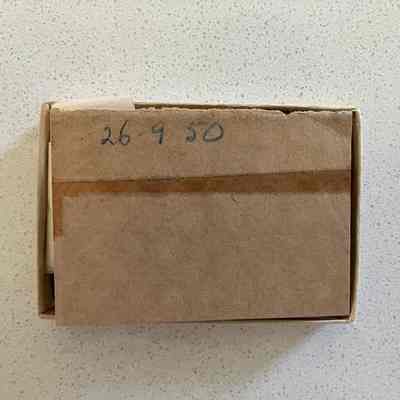 2023.1.33r (2): Paper wrapper that has broken away. 2023.1.33r (2) shows the other half of the full wrapper, rotated for ease of reading. The two parts were secured by adhesive tape which has come away.