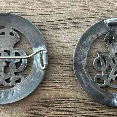 L: 2023.11.3.1 R: 2023.11.3.2: Reverse of two Silver War Badges showing unique identification number and missing pin.