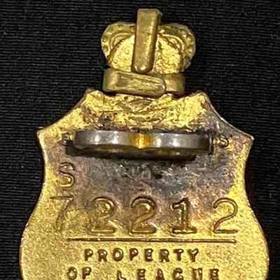 Detail reverse of RSL pin: Gold shield with membership number S72212 and “Property of League”. Maker’s mark: Swann & Hudson VIC.