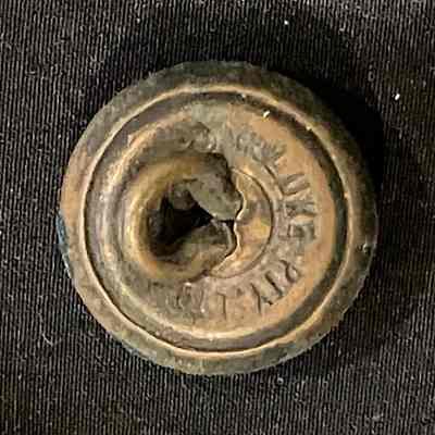 2023.1.13.1r: Reverse of small brass uniform button