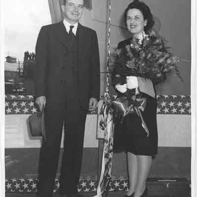 Mr. and Mrs. John H. Purves holding roses at ship christening