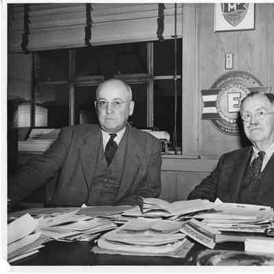 L.D. Smith and man sitting at table in office