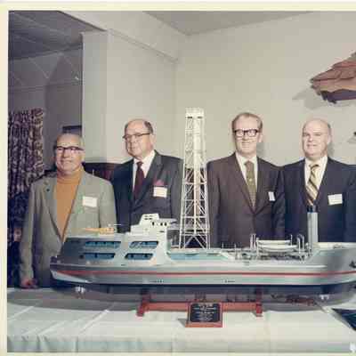 Bob and Fred Peterson with three men behind Alcoa Seaprobe model