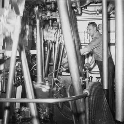 Crewman oiling machine on lighthouse tender Hollyhock