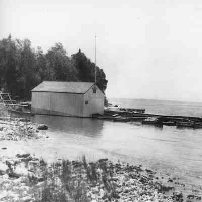 showing boat house at Cana Island dock and lighthouse tender Dahlia 1913