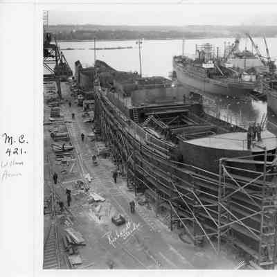 William Homan in scaffolding with workman walking alongside November 24, 1942