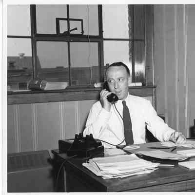 Male employee at desk with phone at L.D. Smith office