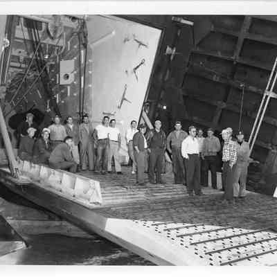 Group of men standing on landing platform of LST-1166, September 4, 1953