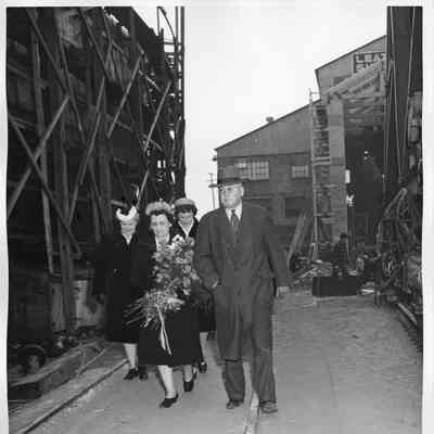 Leathem D. Smith and ship sponsor walking through Smith yard